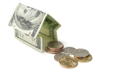 US dollar house and coins on white backgroundの写真素材