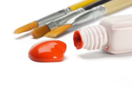 Red water color paint and brushes on white background