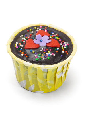 Chocolate cupcake decorated with floral toppings on white backgroundの写真素材