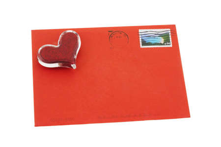 Heart shape symbol on red greeting card envelope with copy space for name and addressの写真素材