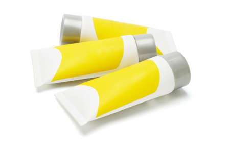 Plastic tubes with yellow labels on white backgroundの写真素材