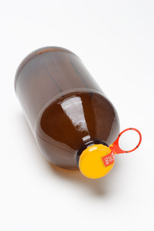 Bottle of fruit juice with yellow metal cap on white background