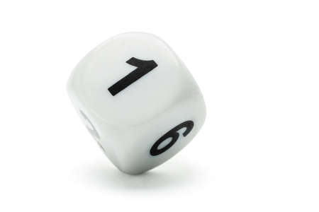 White dice with numbers 1 and 6 standing on white background with copy spaceの写真素材