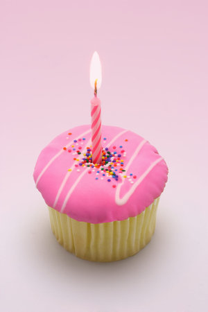 Pink candle in cup cake for first birthdayの写真素材