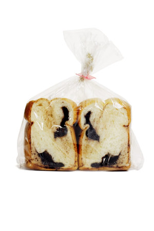 Slices of chocolate loaded bread in plastic bag on white background