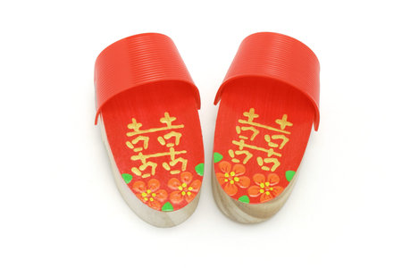 Pair of hand painted red Double Happiness clogs on white background