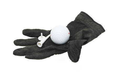 Golf ball, tee and marker on a piece of used and worn black gloveの写真素材