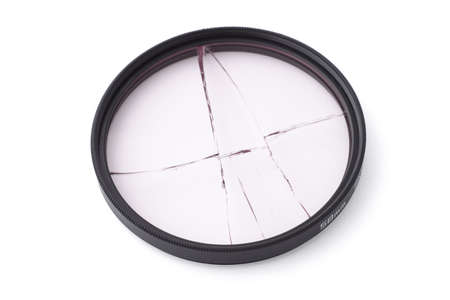 Broken camera lens UV filter on white backgroundの写真素材