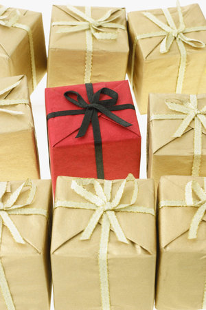 Standalone red gift box surrounded by brown boxes