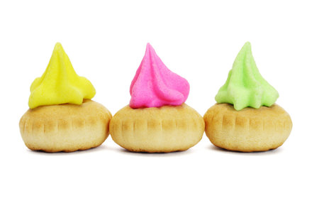 Three colorful icing topped cookies on white background