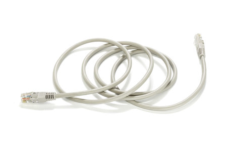 Network cable and plugs lying on white background