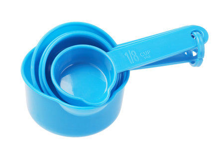 Set Of Plastic Measuring Spoons On White Background