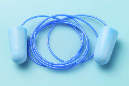 Pair of Ear Plugs on Blue Backgroundの写真素材
