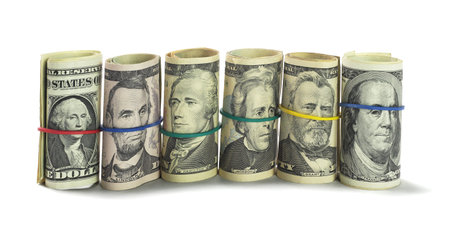 Rolls of US Dollars Standing on White Background