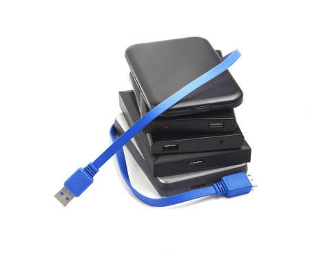 Computer Hard Disks and USB Cable on White Backgroundの写真素材