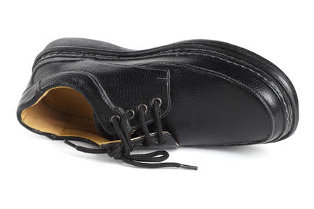 Black Leather Shoe Lying on White Backgroundの写真素材