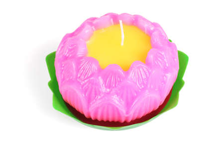 Buddhist Lotus Flower Shape Wax Candle on White Backgroundの写真素材