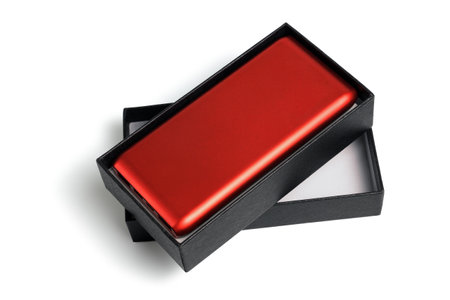 Red Power Bank in Black Paper Box on White Backgroundの写真素材