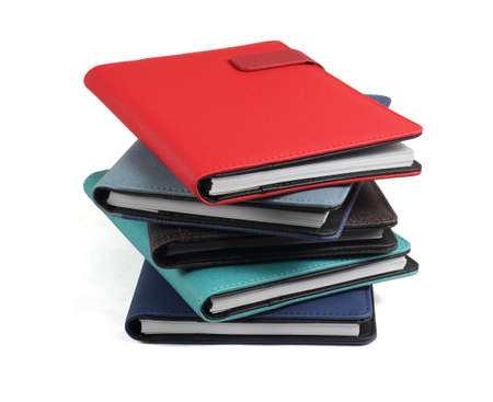 Stack of Colourful Diaries on White Backgroundの写真素材