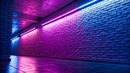 A dark brick corridor illuminated by pink and blue neon lights that cast reflections on the floor.の素材