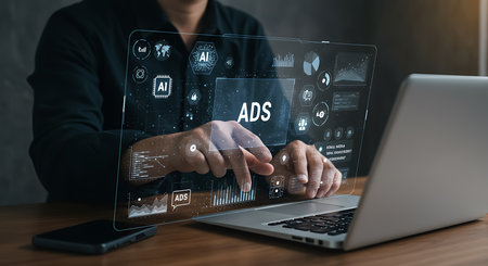 Hands interact with a transparent digital screen displaying ADS and AI icons with charts and graphs.の素材