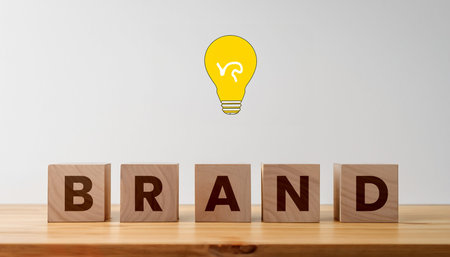 BRAND text on wooden cubes with light bulb, Business conceptの写真素材