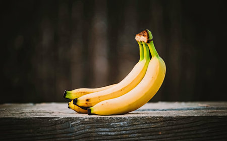 Bunch of bananas on a wooden table. Selective focus.の素材