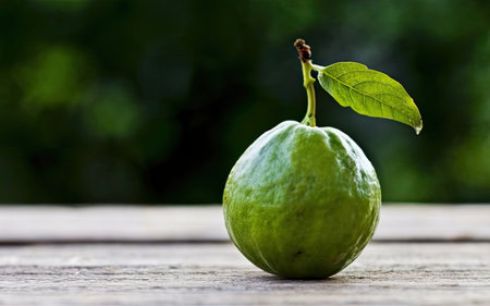Fresh guava fruit on wooden table with nature background, selective focusの素材