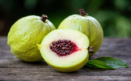Fresh guava fruit on wooden table. Green guava background.の素材