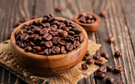 Coffee beans in wooden bowl on rustic wooden background.の素材