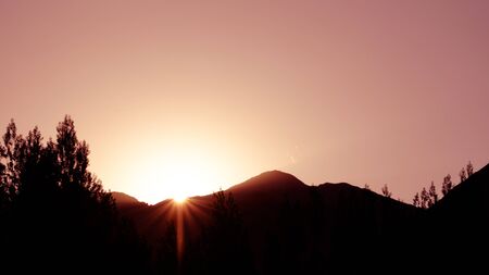 background of sihluate sunrise behind mountainの写真素材