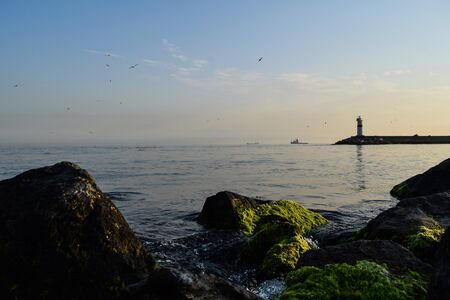 Beautiful sunset over industrial harbor with light house on Istanbul, Turkeyの写真素材
