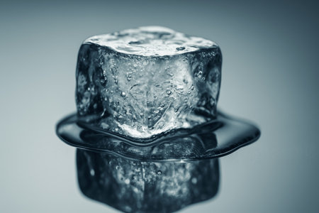 Ice cube on gray background. Selective focus. Toned.の素材