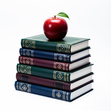 Stack of books with apple on top isolated on a white background.の素材