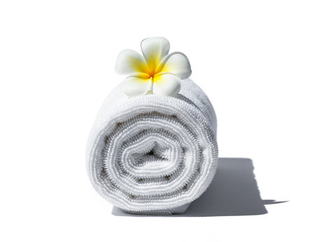 White spa towel with frangipani flower isolated on white backgroundの素材