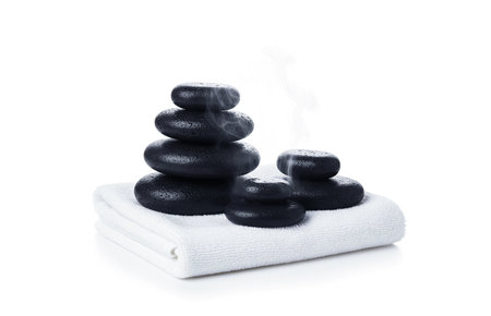 Spa stones and towels on white background. Massage concept.の素材
