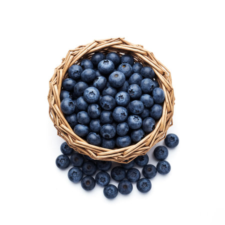 Blueberries in a wicker basket isolated on white background. Top view.の素材