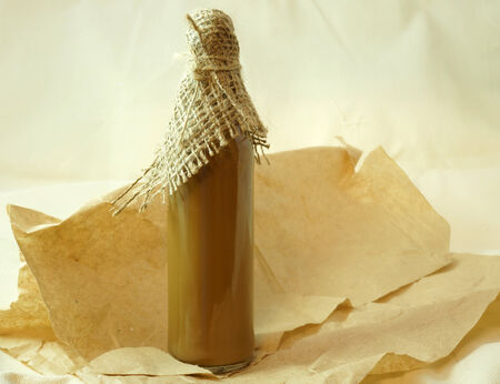 bottle with healthy tincture over old paper background. Herbal medicineの写真素材