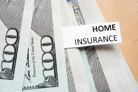 Paper with words home insurance and money.の写真素材