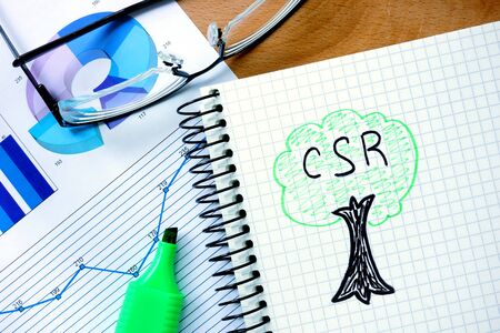 Notepad with csr Corporate social responsibility on office wooden table.の写真素材