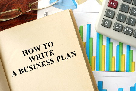 Words how to write a business plan  written on a book. Business concept.の写真素材
