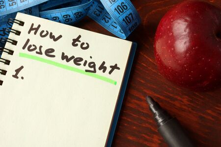 Notebook with how to lose weight    sign.の写真素材
