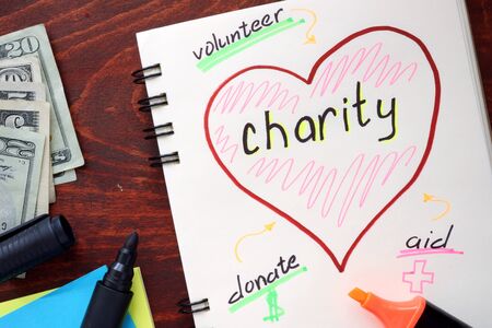 Charity written on notepad on a table.の写真素材
