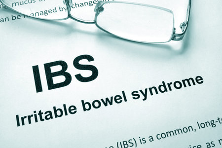 Paper with words Irritable bowel syndrome (IBS) and glasses.