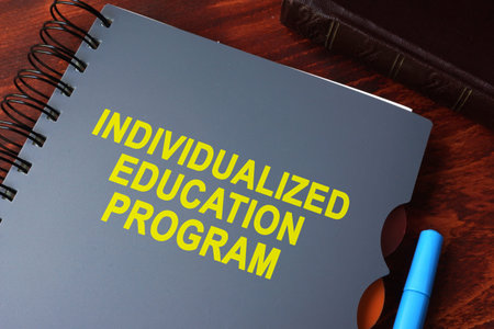 Book with title individualized education program (IEP) on a table.