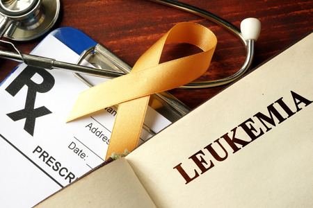 Leukemia written on a page and  orange awareness ribbon.の写真素材