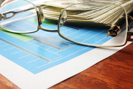 Economical concept. Financial charts  on a wooden surface.の写真素材