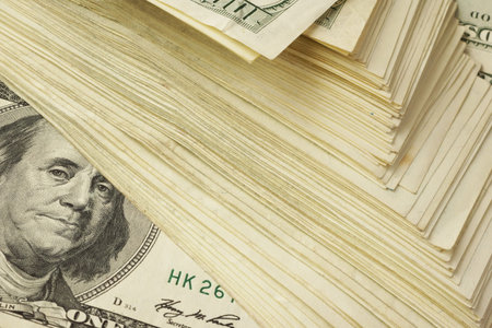 Background with big stack of one hundred dollar banknotes.