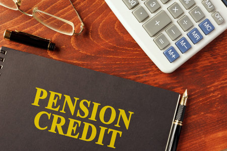 Book with title pension credit and calculator.