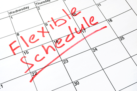 Flexible schedule written on a calendar.の写真素材